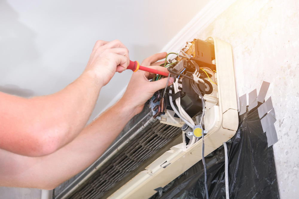 Worker repairing aircon in Singapore